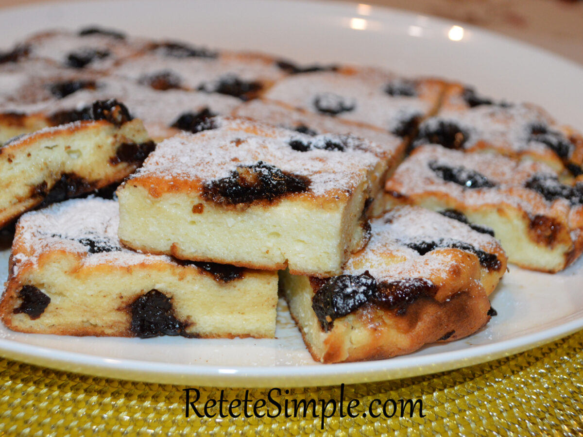 Slice of semolina pudding with golden crust and jam center