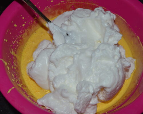 Add the foamed egg whites to the egg yolk mixture