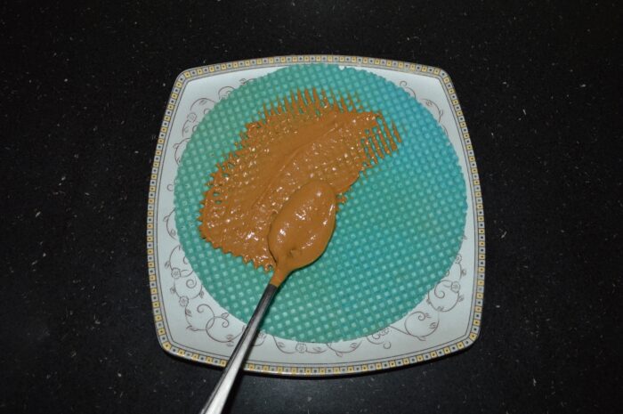 Place a waffle on a plate or platter and spread