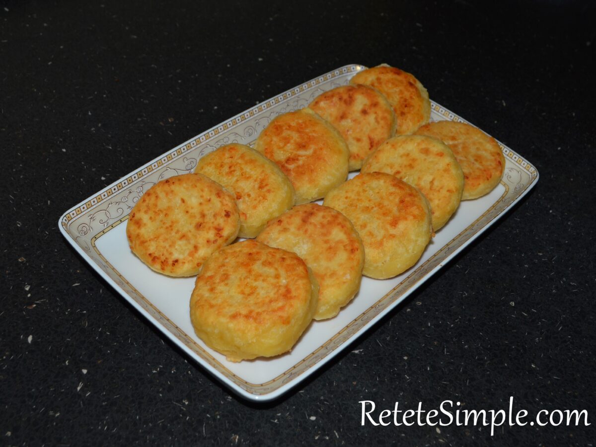 Frying cottage cheese pancakes on plate