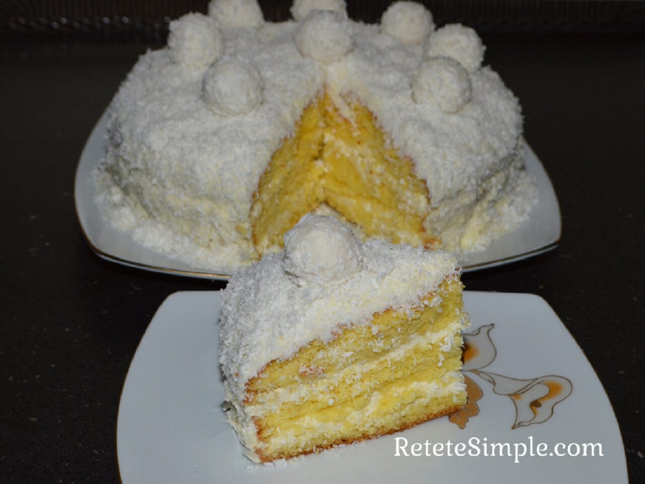 Raffaello cake on white plate with coconut shreds