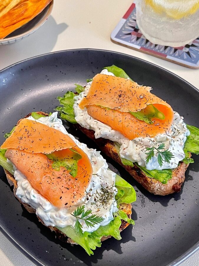 Close-up of creamy cheese layer with smoked salmon edge