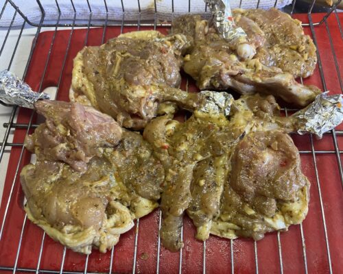 Marinating chicken thighs overnight in savory garlic-spice blend