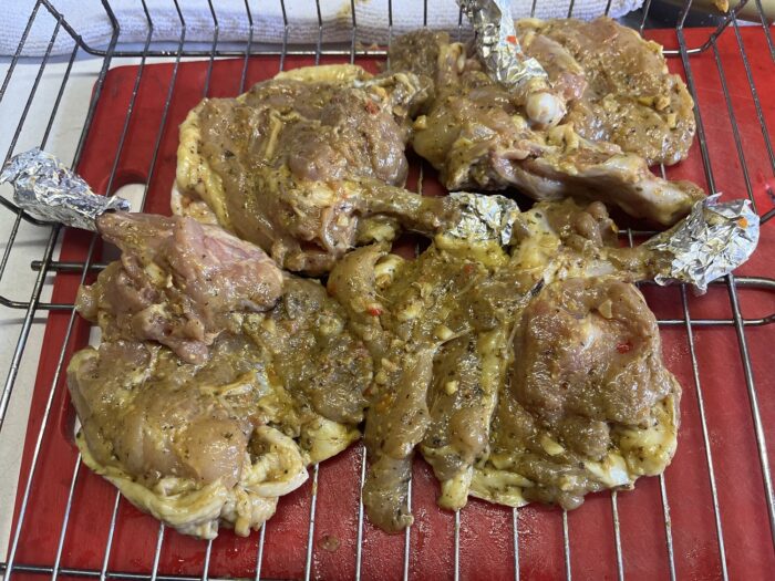 Marinating chicken thighs overnight in savory garlic-spice blend