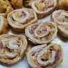 Chicken roll stuffed with cheese, onion and garlic, wrapped in bacon and sliced