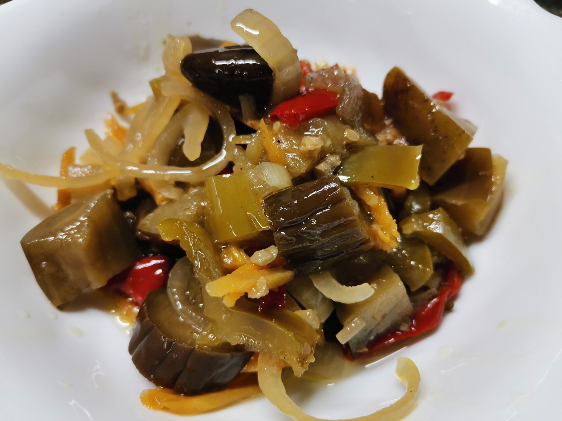 Rustic jar of eggplant veggie stew with colorful layers