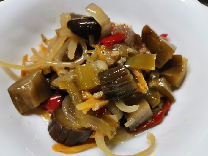 Rustic jar of eggplant veggie stew with colorful layers