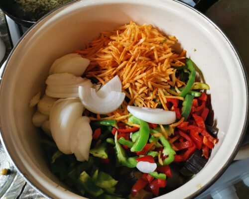 Add carrots, peppers, and onions to eggplant