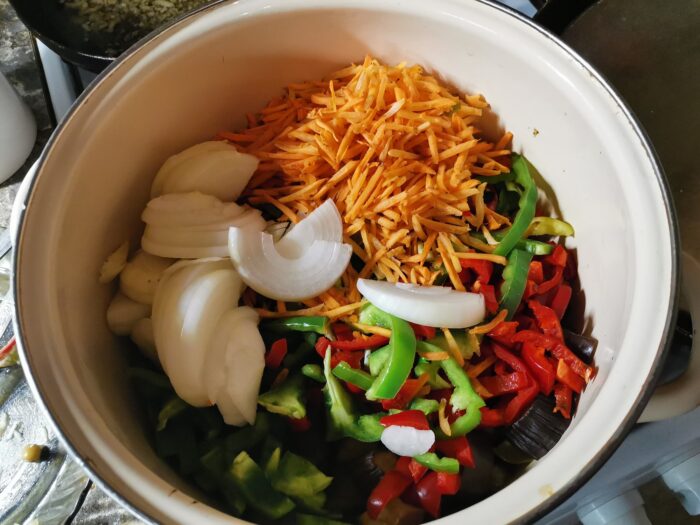 Add carrots, peppers, and onions to eggplant
