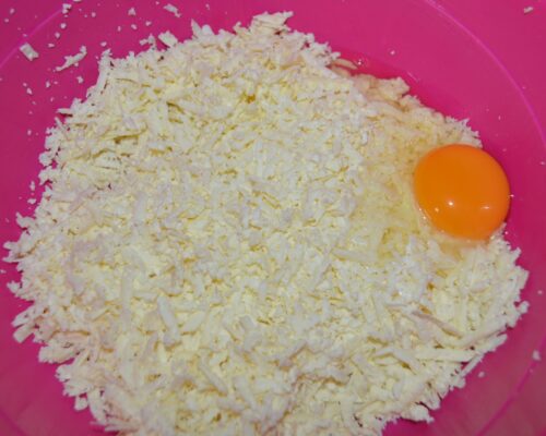 shave the salted cheese and add an egg