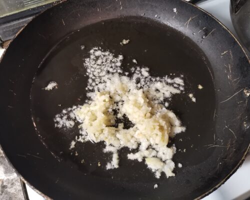 Peel 1-1.5 heads of garlic and press through a press