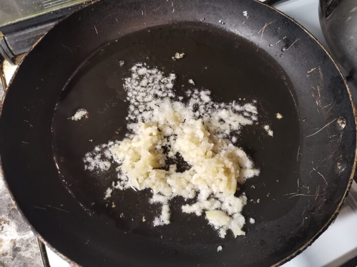 Peel 1-1.5 heads of garlic and press through a press