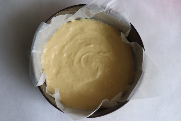 Pour some of the dough into the pan