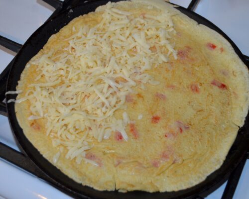 Put the grated cheese on half of the pancake.