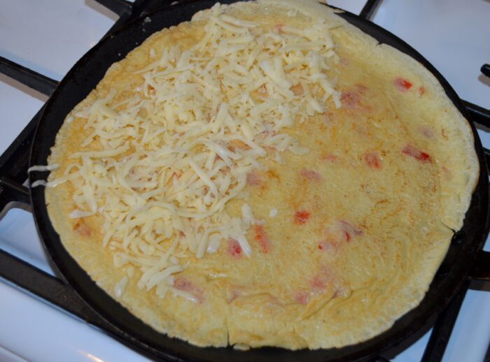 Put the grated cheese on half of the pancake.
