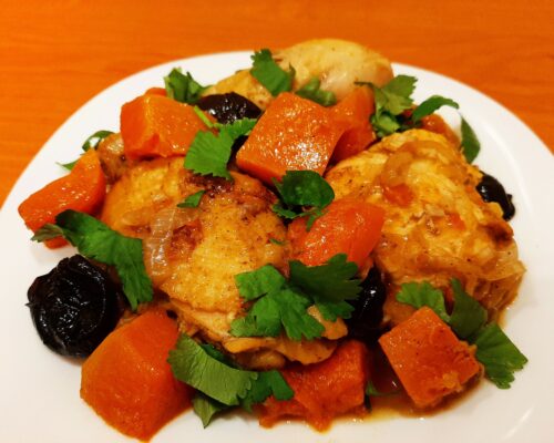 Chicken pumpkin prune dish garnished with fresh parsley