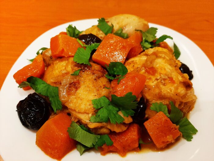 Chicken pumpkin prune dish garnished with fresh parsley
