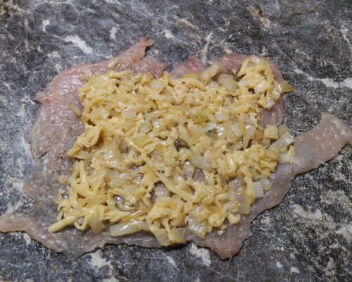 Place the cheese and onion mixture on the chicken chop