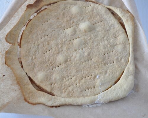 Place the rolled-out dough circle in the oven