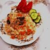 Close-up of rice pilaf with tender beef ribs and vegetables