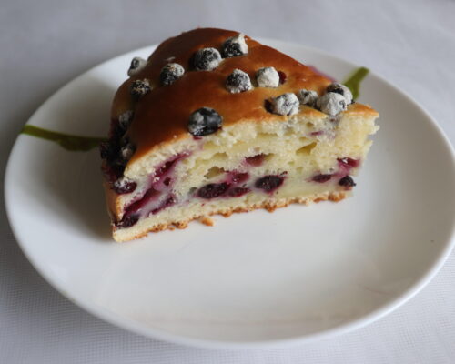 The cake is dense, with berries evenly distributed throughout