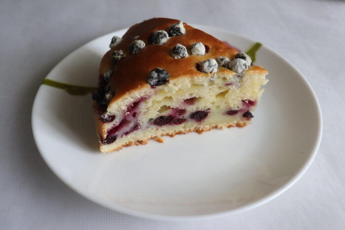 The cake is dense, with berries evenly distributed throughout
