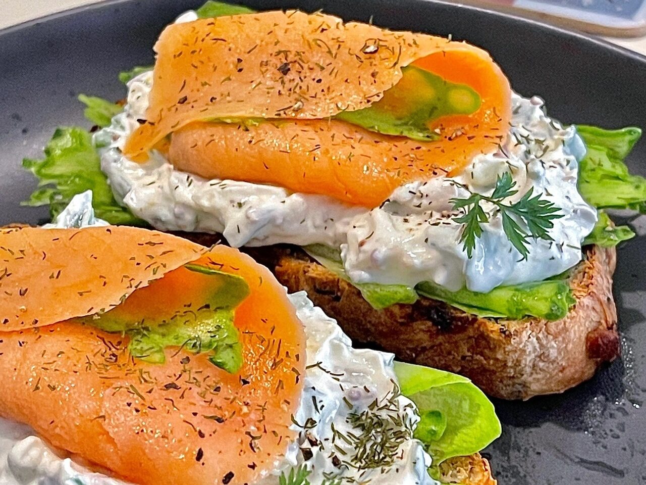 Open smoked salmon sandwich with cream cheese and cucumber