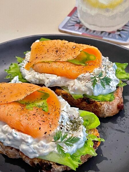 Open smoked salmon sandwich with cream cheese and cucumber