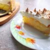 Slice of lemon meringue cake with fluffy meringue cloud