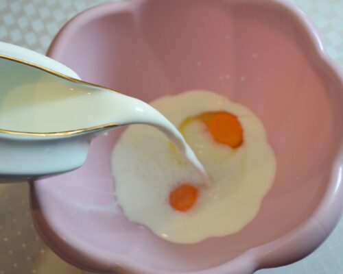 Pour in the milk and mix with a whisk