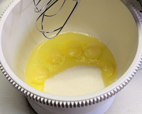 Beat the eggs with the remaining sugar