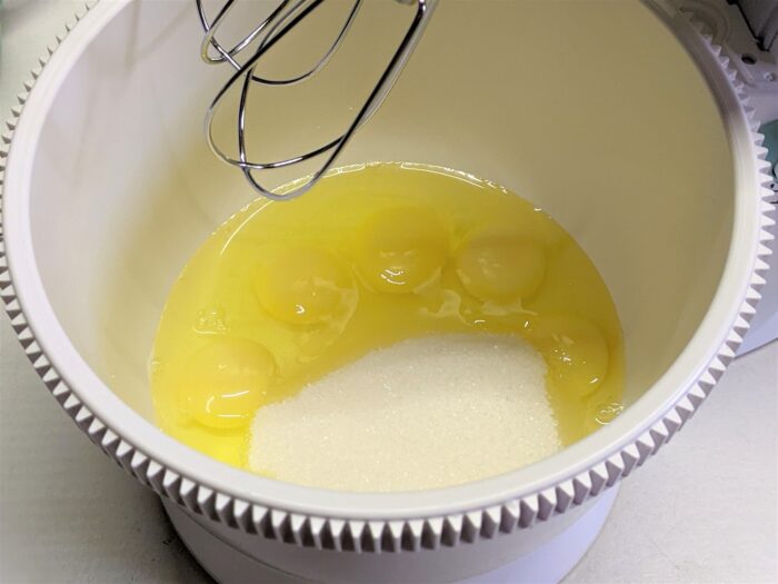 Beat the eggs with the remaining sugar