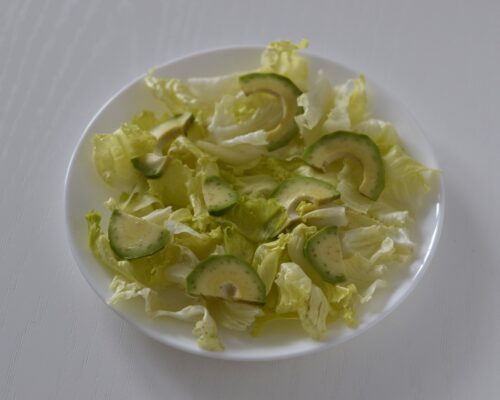Arrange the avocado slices on the lettuce leaves