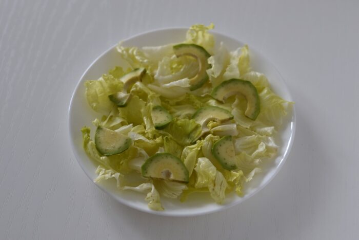 Arrange the avocado slices on the lettuce leaves