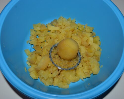 Using a vegetable cutter, cut the potatoes