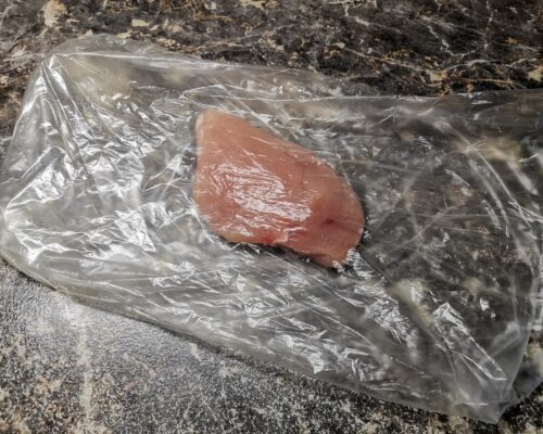 Place chicken fillet pieces in a plastic packet.