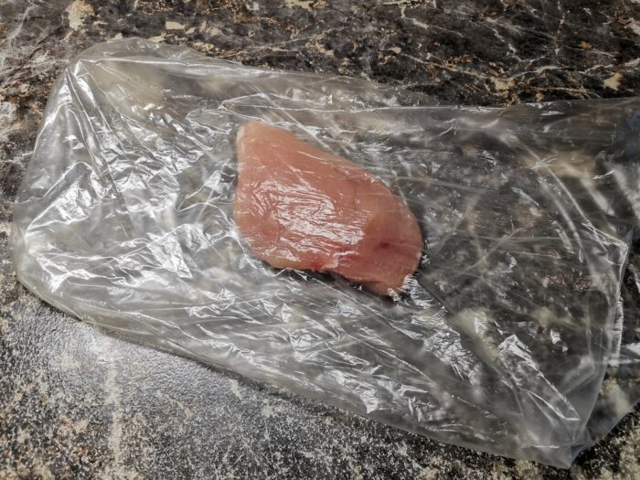 Place chicken fillet pieces in a plastic packet.
