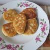 Stack of fluffy kefir pancakes with plum pieces