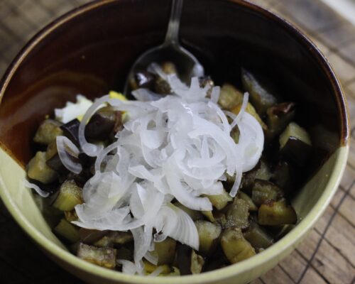Pour the cooled eggplants and dried marinated onions