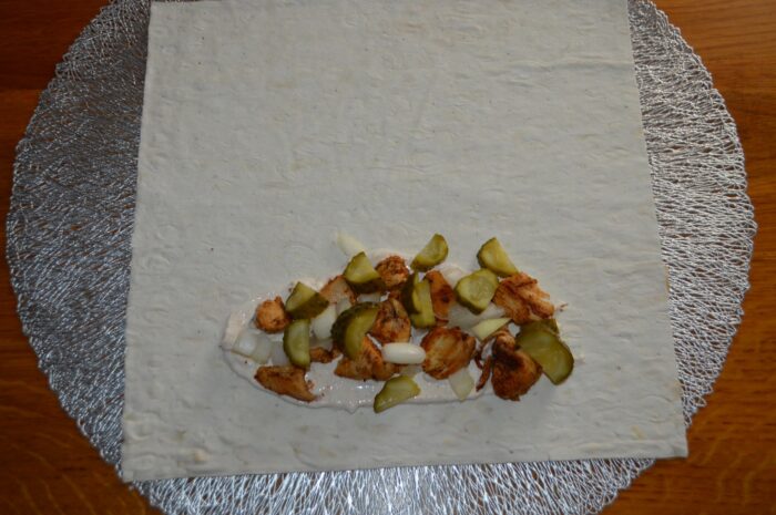 add a layer of onions and pickled cucumbers