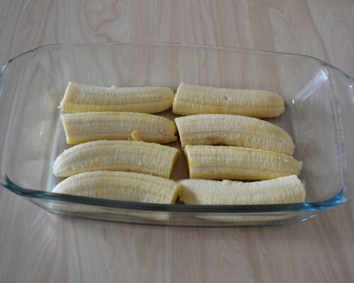 Place the banana in a buttered baking pan