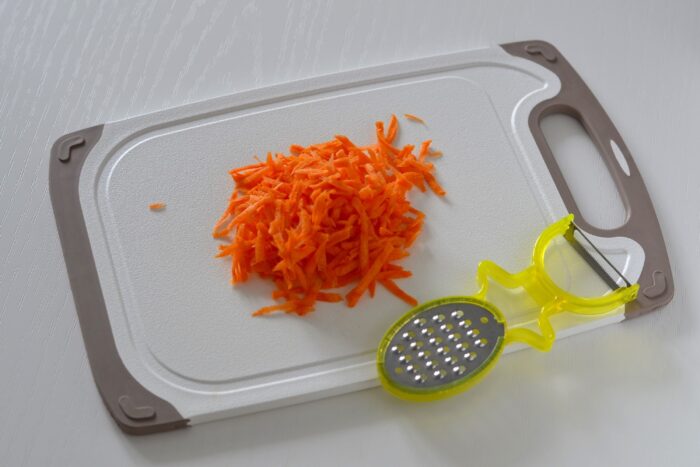 Peel the carrots and grate