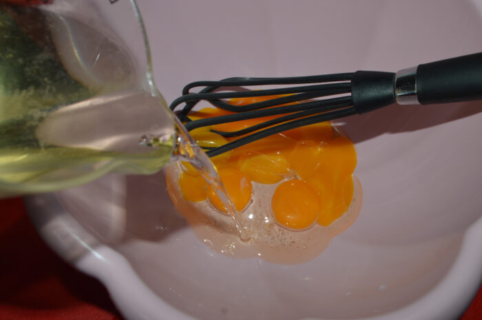 Add oil to egg yolks