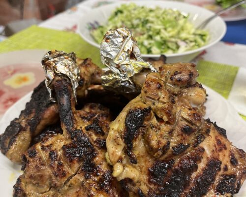 Succulent grilled chicken thighs served with greens