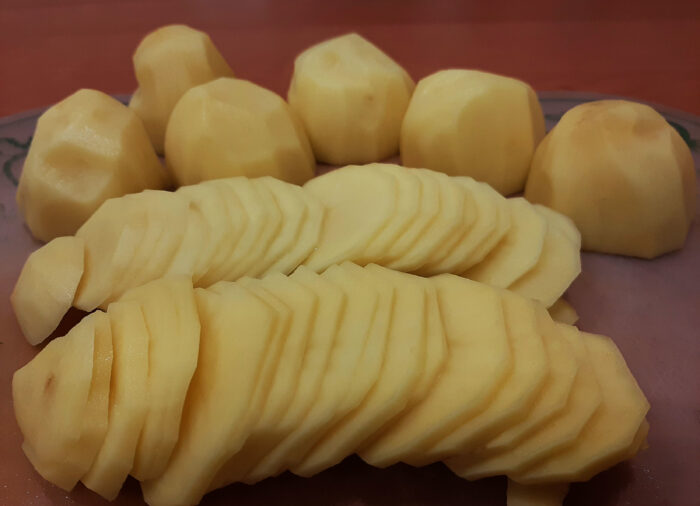 Peel potatoes, and cut