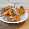 Golden oven-baked wings topped with crunchy peanuts