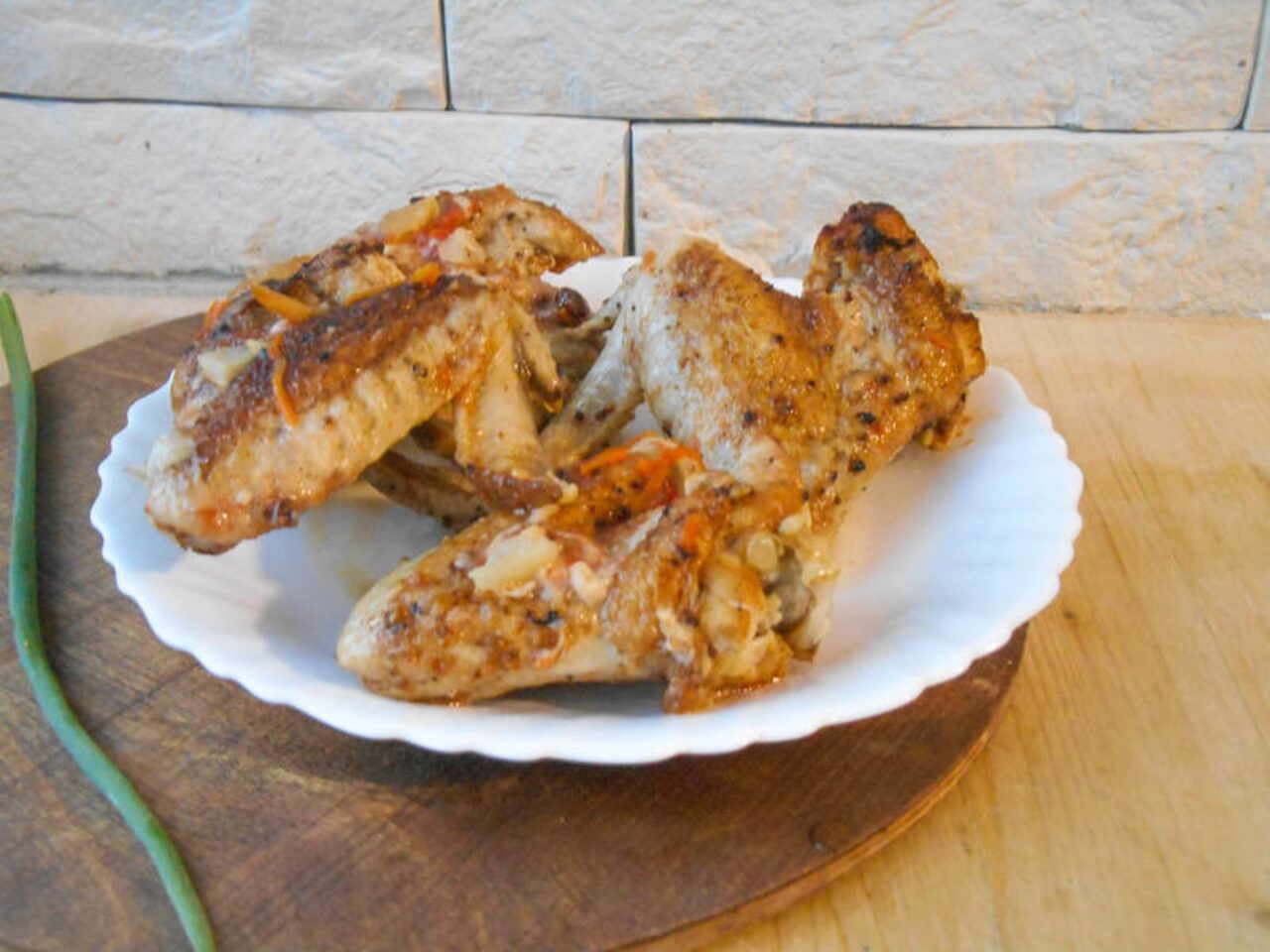 Golden oven-baked wings topped with crunchy peanuts