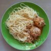 Comforting pasta dish with meatballs and herb-seasoned tomato sauce