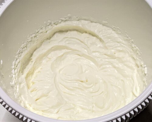 Beat the cheese with the condensed milk