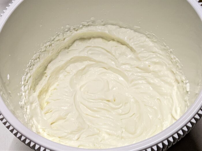 Beat the cheese with the condensed milk